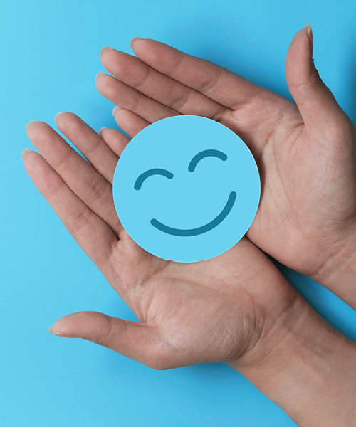 Smiley liegt in Handflächen